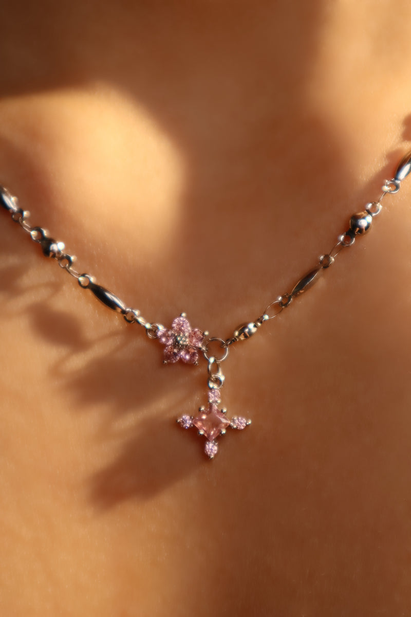 Palladium white-gold-plated cross necklace set with pink zirconia gemstones