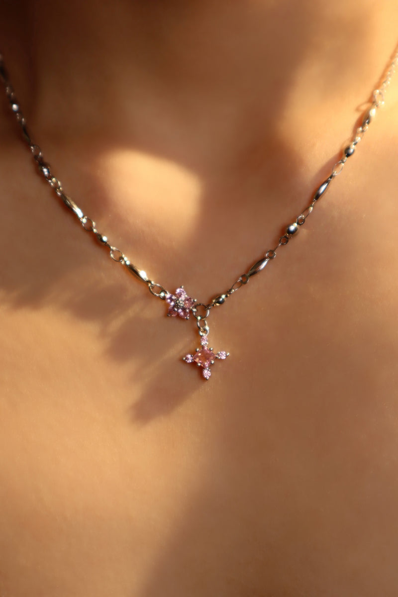 Palladium white-gold-plated cross necklace set with pink zirconia gemstones