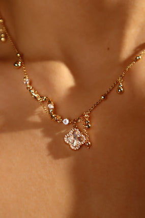 Gold-plated spiral necklace with lucky leaf motif, natural shell pearls and zirconia diamonds