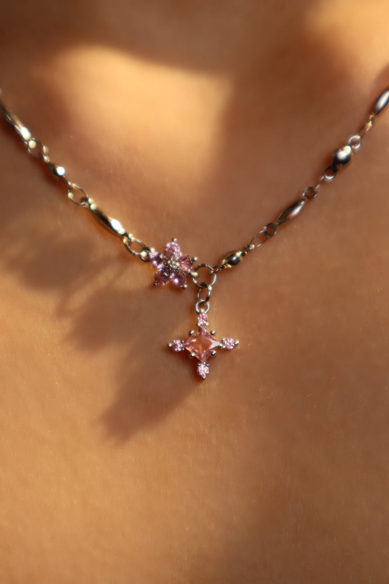 Palladium white-gold-plated cross necklace set with pink zirconia gemstones