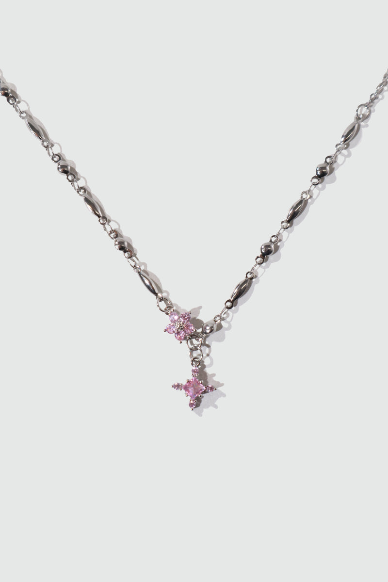 Palladium white-gold-plated cross necklace set with pink zirconia gemstones