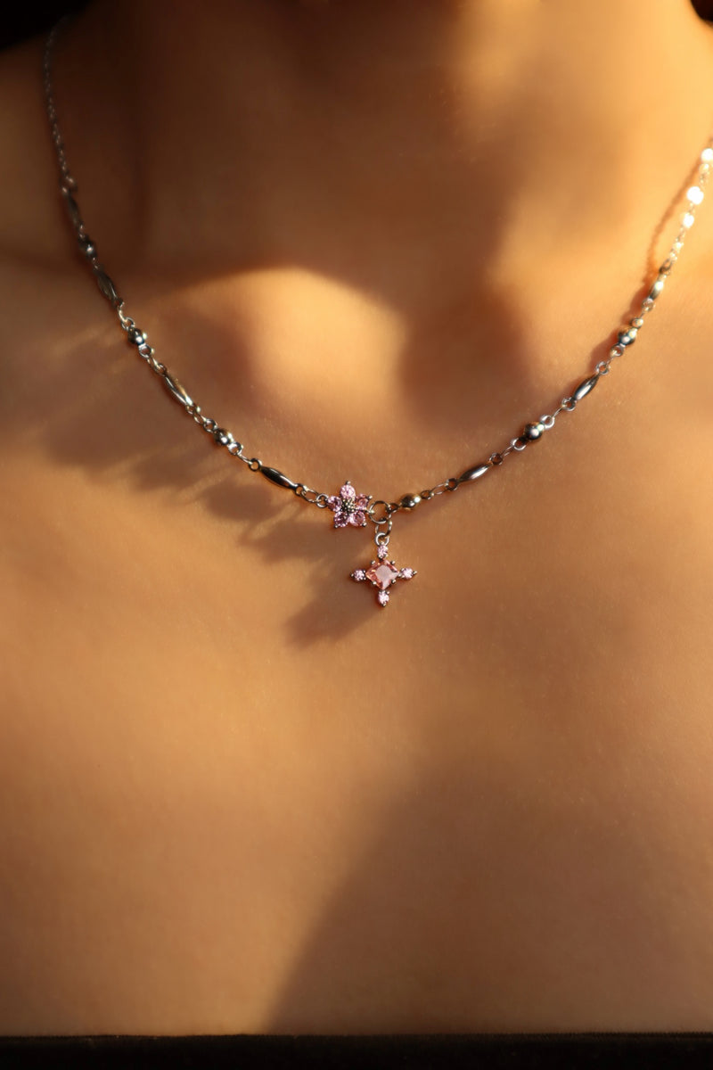 Palladium white-gold-plated cross necklace set with pink zirconia gemstones