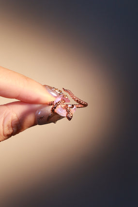 18K rose gold-plated snake ring wrapped around a zirconia moonstone