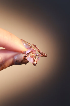 18K rose gold-plated snake ring wrapped around a zirconia moonstone