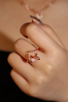18K rose gold-plated snake ring wrapped around a zirconia moonstone