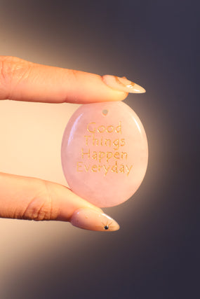Natural rose quartz stone pendant with a soft pink glow