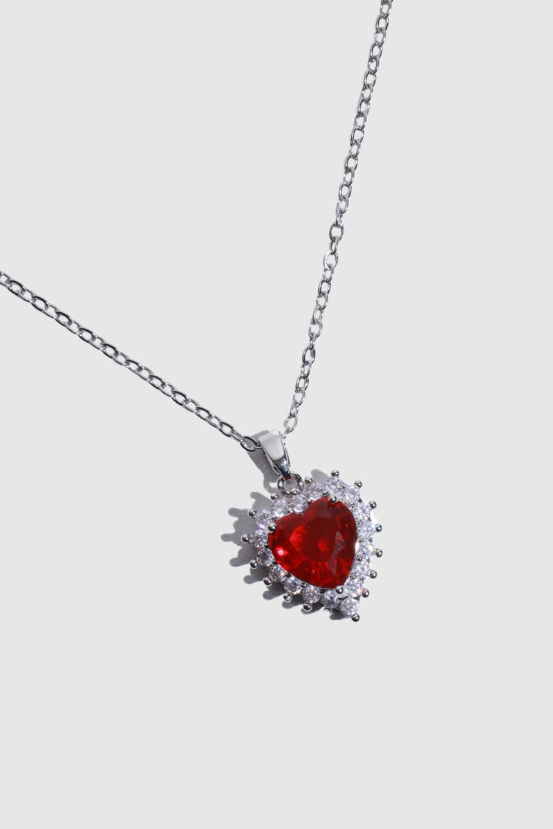 Palladium white gold plated necklace with a red heart gemstone framed in sparkling zirconia