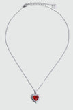 Palladium white gold plated necklace with a red heart gemstone framed in sparkling zirconia