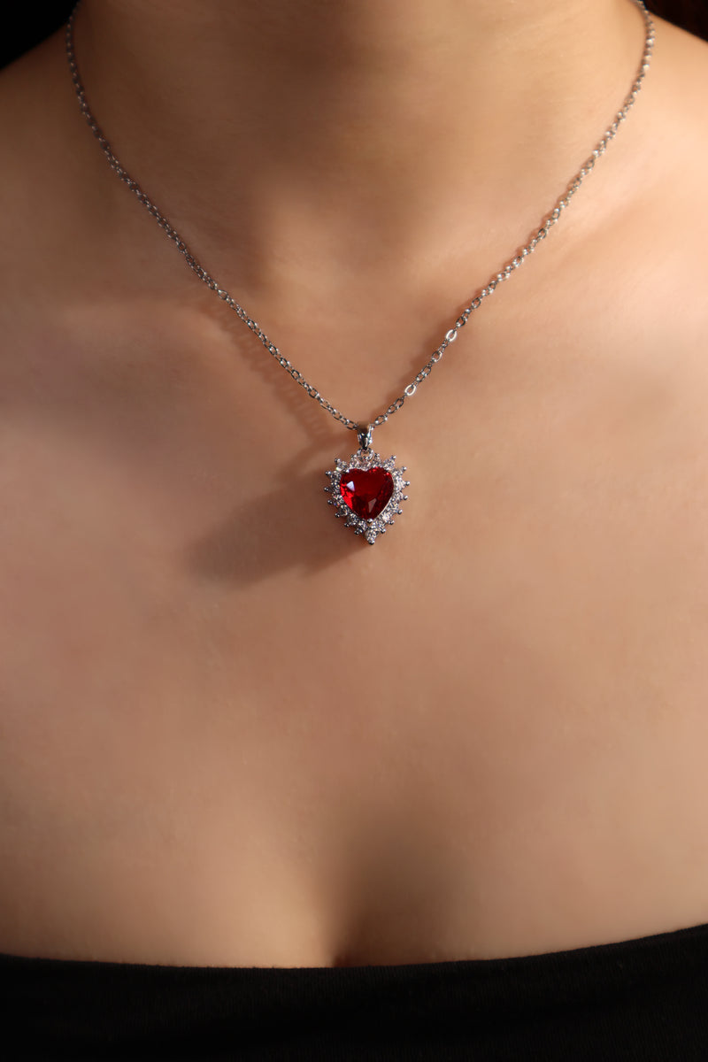 Palladium white gold plated necklace with a red heart gemstone framed in sparkling zirconia