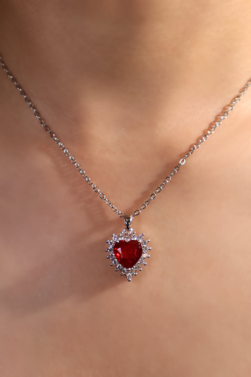 Palladium white gold plated necklace with a red heart gemstone framed in sparkling zirconia