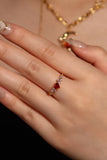 18K gold plated ring with a red crimson heart gemstone and sparkling zirconia on an adjustable band