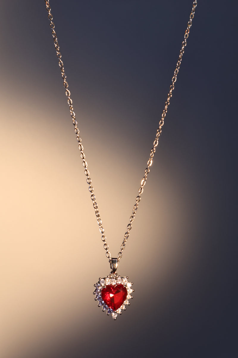 Palladium white gold plated necklace with a red heart gemstone framed in sparkling zirconia