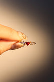 18K gold plated ring with a red crimson heart gemstone and sparkling zirconia on an adjustable band