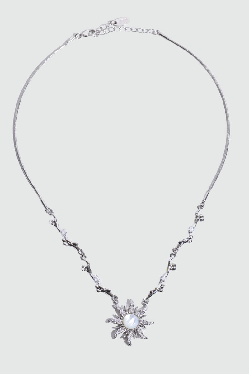 Palladium white gold plated sun necklace with a white natural shell and sparkling zirconia