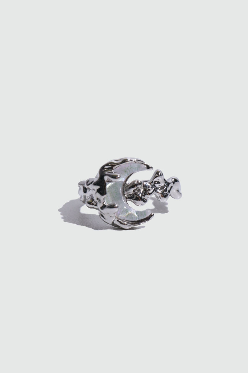 Silver plated ring with a glowing white zirconia moonstone on an adjustable band