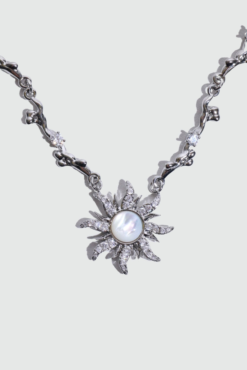 Palladium white gold plated sun necklace with a white natural shell and sparkling zirconia