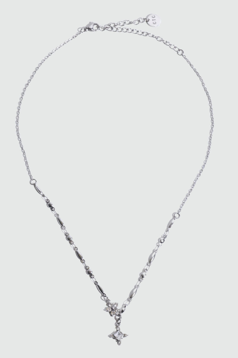 Stainless steel cross necklace traced with sparkling zirconia diamonds like scattered starlight