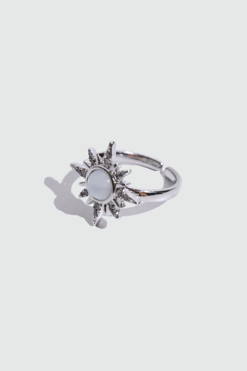 Silver plated sun ring with a glowing white zirconia moonstone and sparkling zirconia on an adjustable band