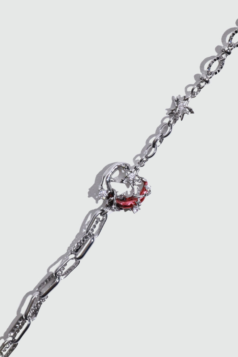 Silver plated bracelet with a glowing red resin crescent moon and sparkling zirconia