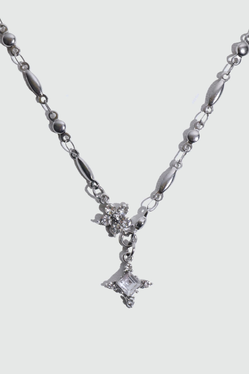 Stainless steel cross necklace traced with sparkling zirconia diamonds like scattered starlight