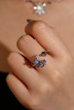 Silver plated ring with a purple resin moon, butterfly and sparkling zirconia on an adjustable band
