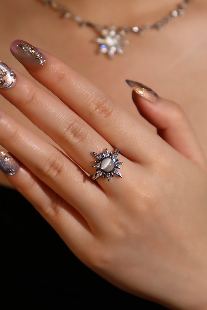 Silver plated sun ring with a glowing white zirconia moonstone and sparkling zirconia on an adjustable band