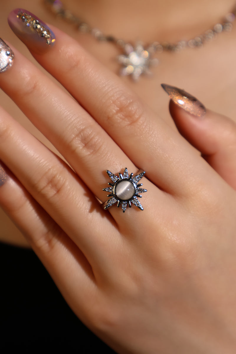 Silver plated sun ring with a glowing white zirconia moonstone and sparkling zirconia on an adjustable band
