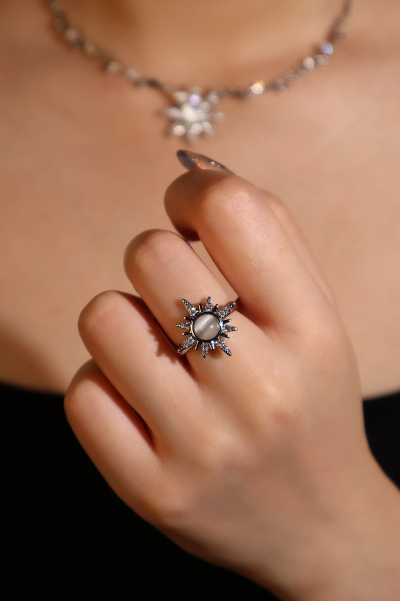 Silver plated sun ring with a glowing white zirconia moonstone and sparkling zirconia on an adjustable band
