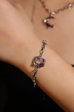 Silver plated bracelet with a glowing red resin crescent moon and sparkling zirconia