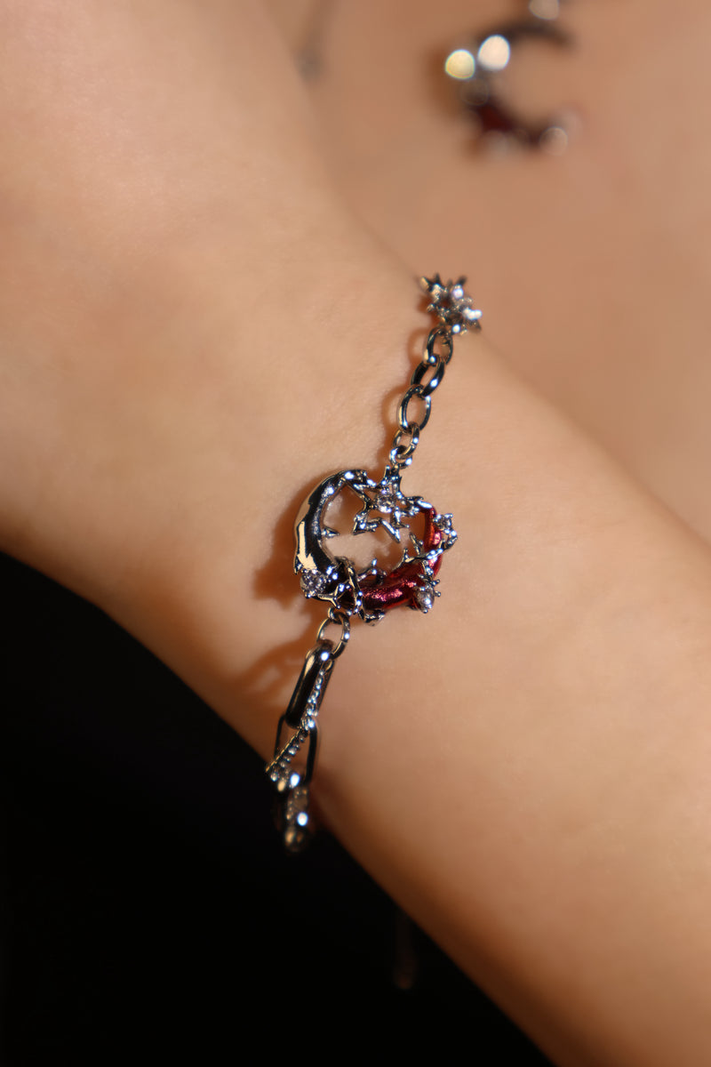 Silver plated bracelet with a glowing red resin crescent moon and sparkling zirconia