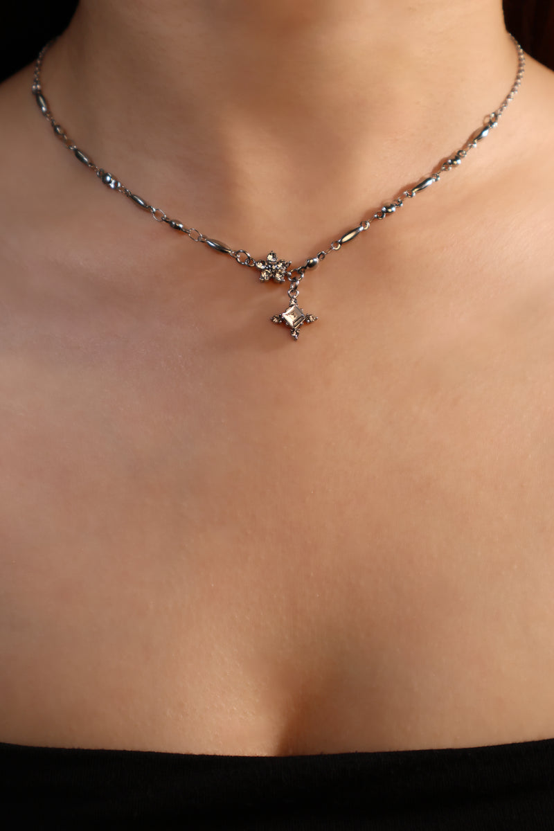 Stainless steel cross necklace traced with sparkling zirconia diamonds like scattered starlight