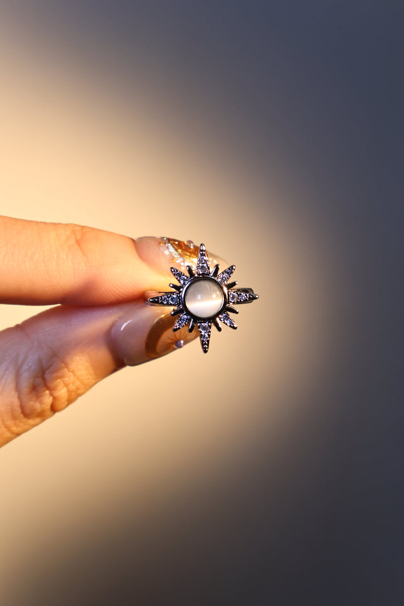 Silver plated sun ring with a glowing white zirconia moonstone and sparkling zirconia on an adjustable band