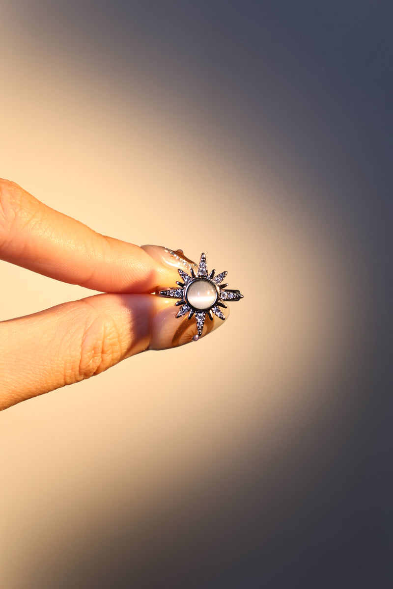 Silver plated sun ring with a glowing white zirconia moonstone and sparkling zirconia on an adjustable band