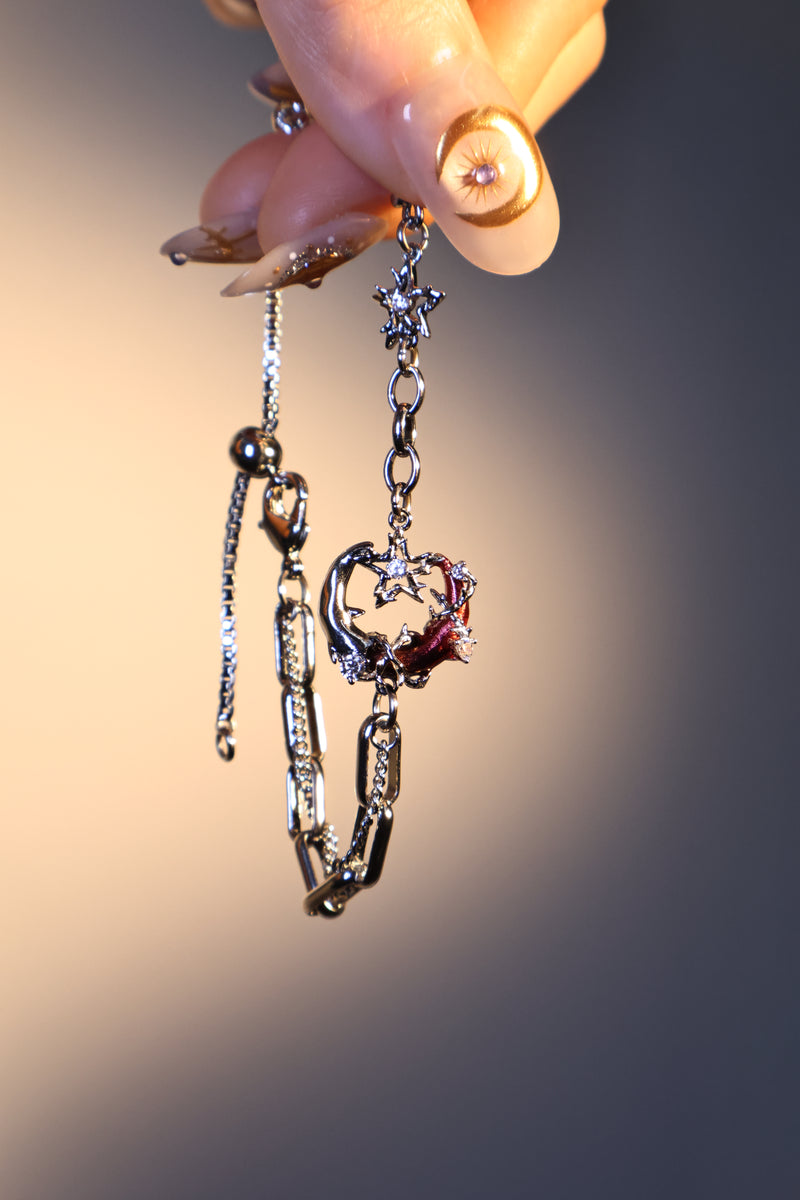 Silver plated bracelet with a glowing red resin crescent moon and sparkling zirconia