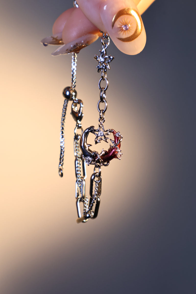 Silver plated bracelet with a glowing red resin crescent moon and sparkling zirconia
