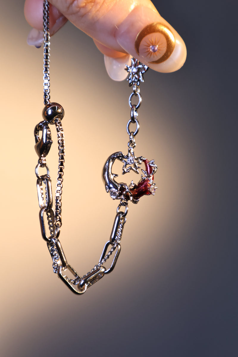 Silver plated bracelet with a glowing red resin crescent moon and sparkling zirconia
