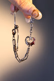 Silver plated bracelet with a glowing red resin crescent moon and sparkling zirconia