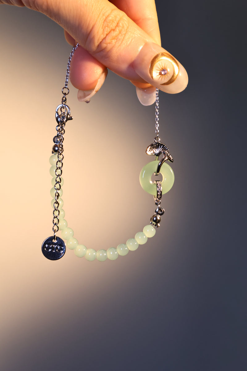 Palladium white gold plated bracelet with a jade ginkgo leaf and sparkling zirconia diamonds
