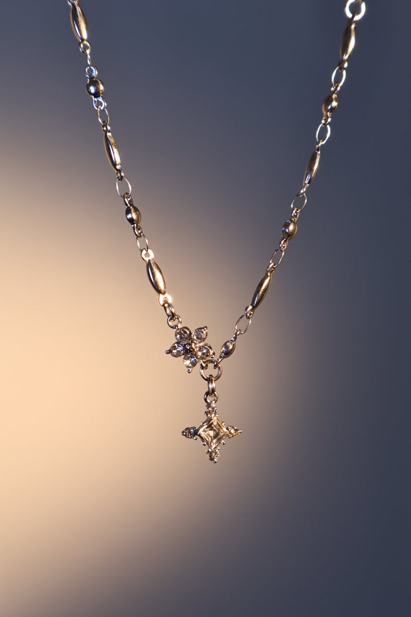 Stainless steel cross necklace traced with sparkling zirconia diamonds like scattered starlight