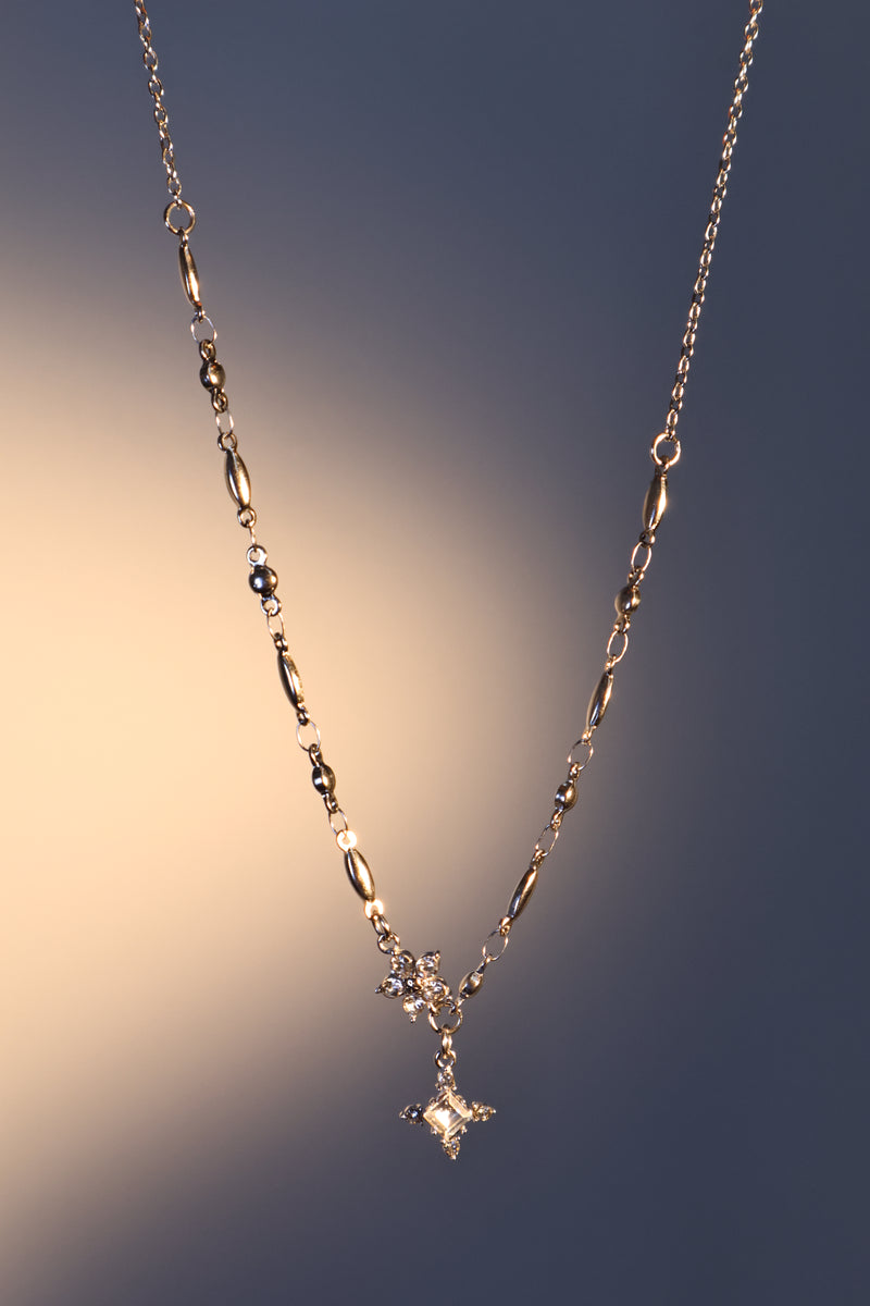Stainless steel cross necklace traced with sparkling zirconia diamonds like scattered starlight