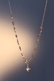 Stainless steel cross necklace traced with sparkling zirconia diamonds like scattered starlight
