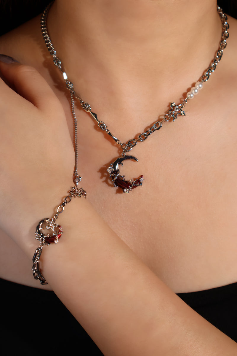 Silver plated bracelet with a glowing red resin crescent moon and sparkling zirconia
