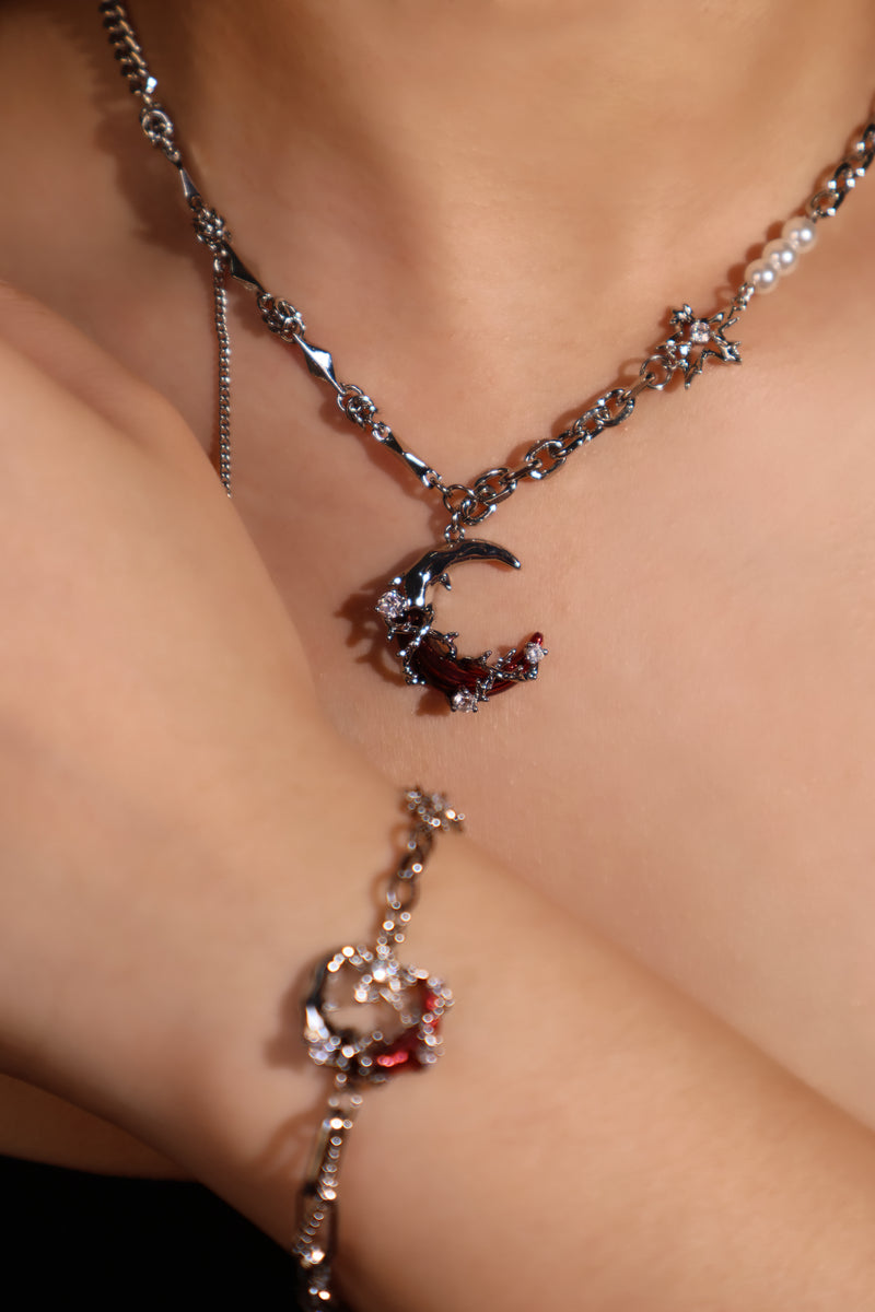Silver plated bracelet with a glowing red resin crescent moon and sparkling zirconia