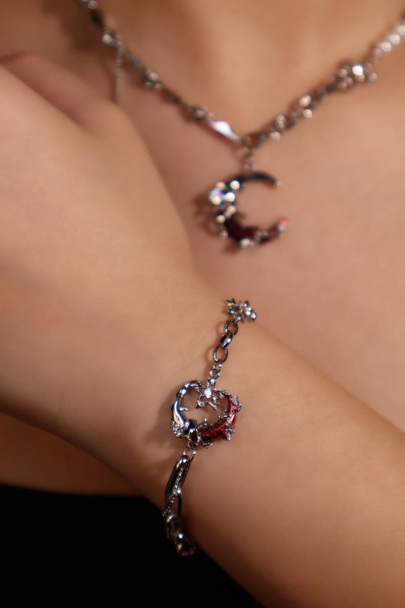 Silver plated bracelet with a glowing red resin crescent moon and sparkling zirconia