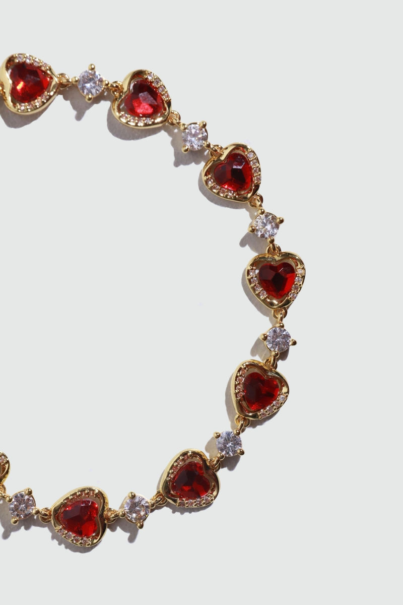 18K gold plated bracelet with a row of sparkling red zirconia hearts and clear zirconia