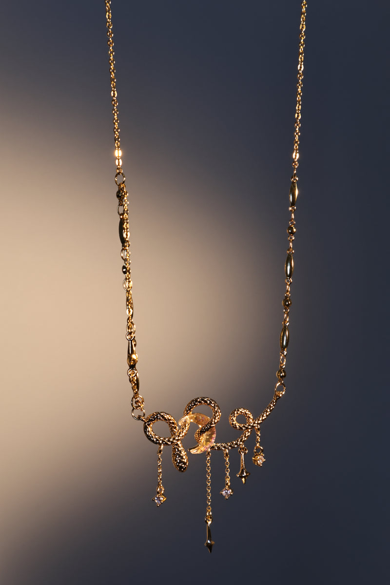 18K gold plated moon snake necklace with a glowing zirconia moonstone and sparkling zirconia
