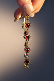 18K gold plated bracelet with a row of sparkling red zirconia hearts and clear zirconia