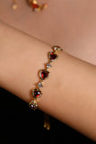 18K gold plated bracelet with a row of sparkling red zirconia hearts and clear zirconia
