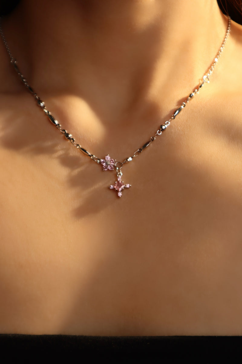 Palladium white-gold-plated cross necklace set with pink zirconia gemstones