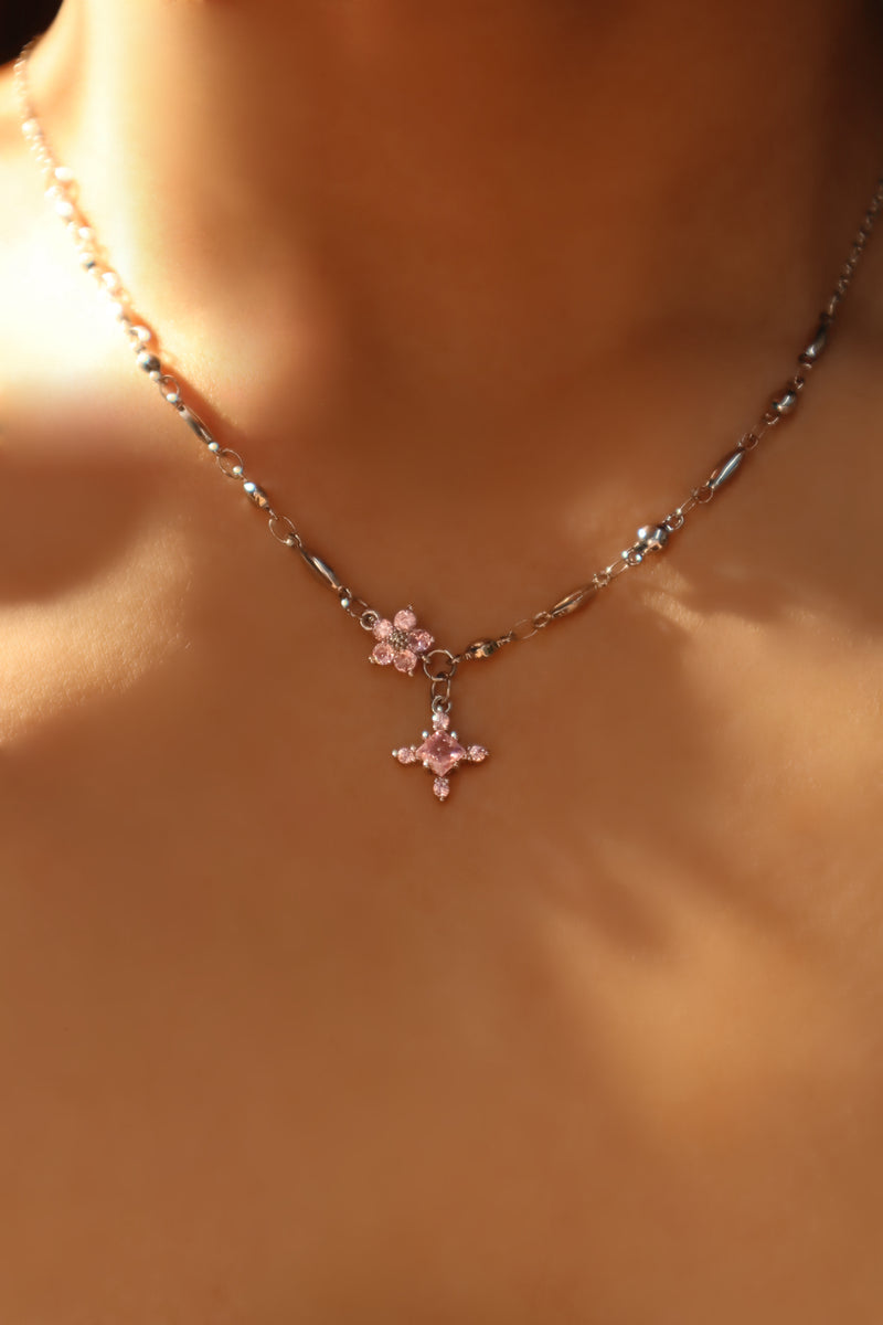 Palladium white-gold-plated cross necklace set with pink zirconia gemstones